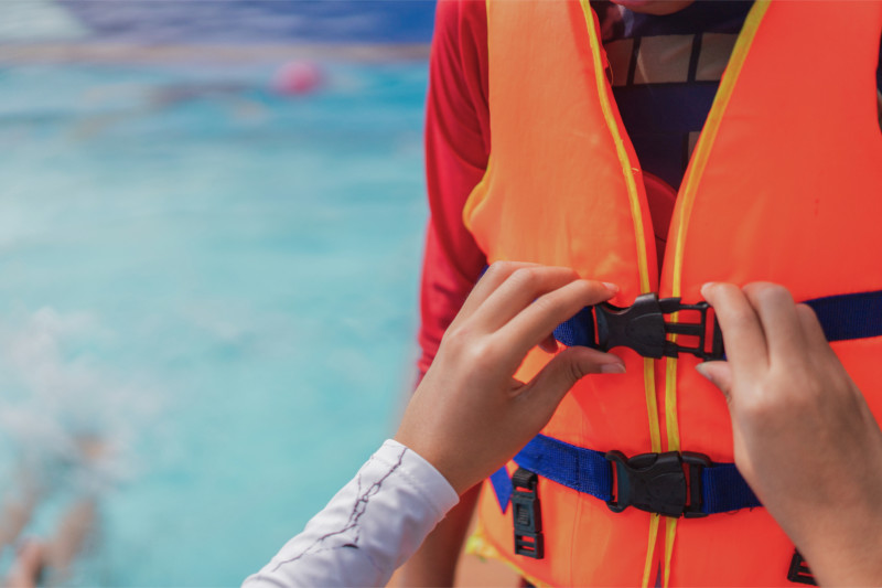 Pasajero ajustándose un chaleco salvavidas antes de una excursión en barco
